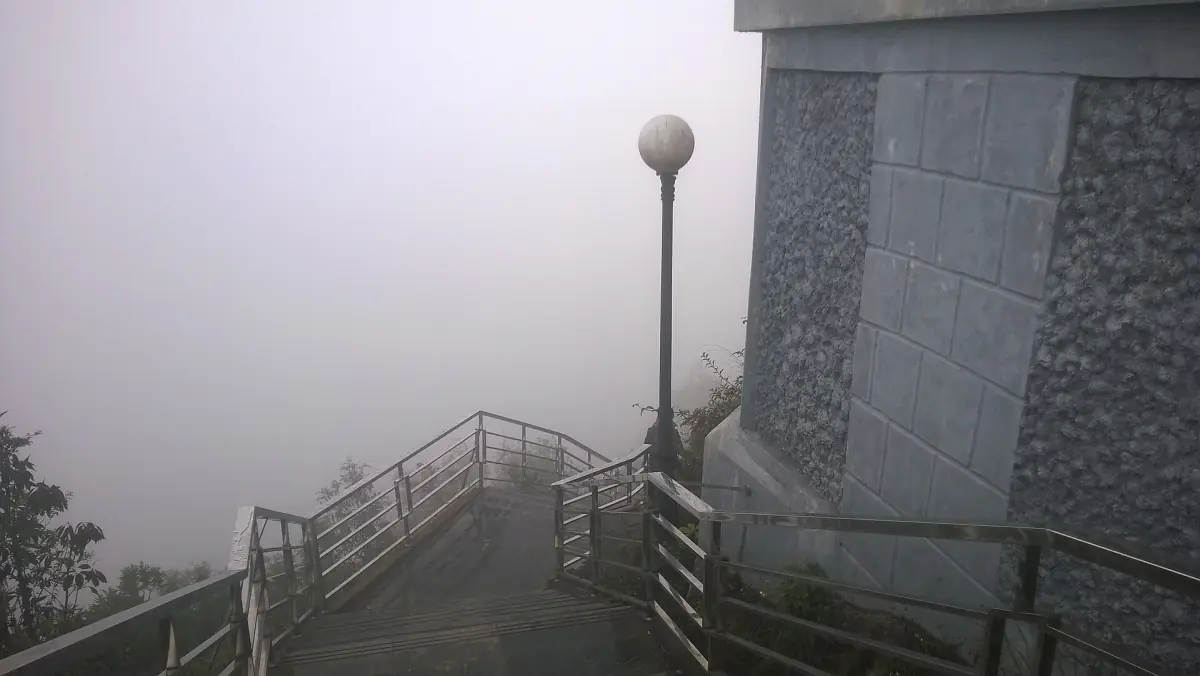 Stone base and steps of the Lung Cu flag tower in mist
